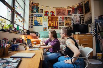 two students studying in a dorm room